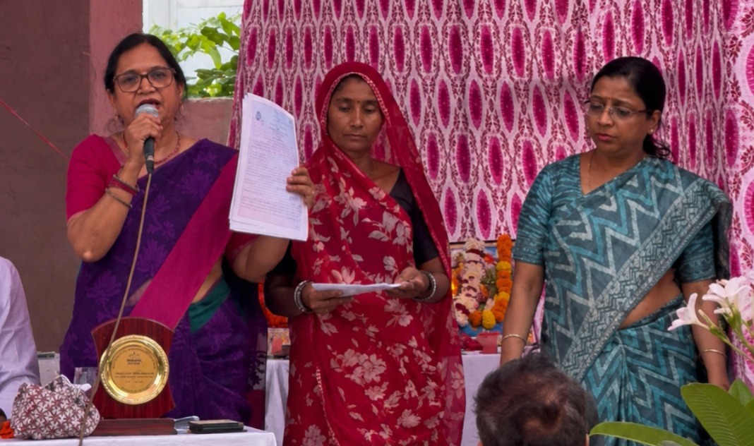 Women and children participating in a social awareness and health camp in Jaipur where birth certificates and sanitary napkins were distributed.